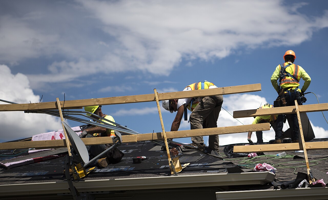 Roofers laying new shingles